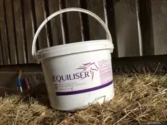 Equiliser 24/7 2.5 kg tub of high performance horse supplement in a stable